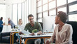 © ReeseBuyout4/peopleimages.com - Office, business and colleagues talking or in discussion while working on a project in a coworking space. Interracial, communication and corporate employees in a conversation or consult in workplace.