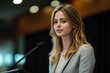 © nupam - Young businesswoman and speaker delivering presentation from a podium at corporate meeting, Generative AI