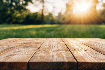 Poster - Empty wooden table illuminating under the warm sunset with a blurred park in the background