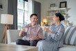 © ultramansk - An elderly couple enjoys a peaceful moment at home, sharing smiles and drinks. The warm and cozy atmosphere emphasizes their deep connection, happiness, and the comfort of spending time together.