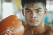 © kittipoj - Young Male Muay Thai Fighter Focused on Training