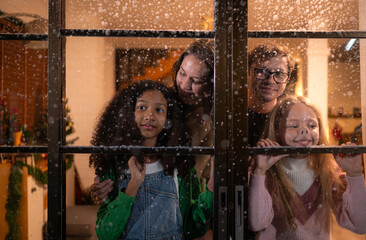 Parents and a teen girl on Christmas night with the first snowfall