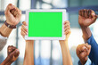 © peopleimages.com - Business people, hands and green screen with tablet for success, advertising or announcement in office. Teamwork, community and employee engagement for group with tech fist, mockup space and support