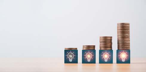 Poster - Increasing coins stacking on glowing lightbulb icon for problem solving solution idea and creative can make more money concept.