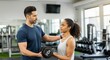 © Rizka - Personal Trainer Guiding a Woman Lifting Weights at the Gym