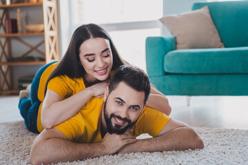 Sticker - Full size photo of two young partners lying carpet floor free time modern interior apartment indoors