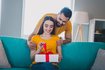 Canvas Print - Portrait of two young people hug open giftbox weekend pastime modern interior flat indoors