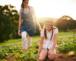 © FotoPush/peopleimages.com - Farm, green and woman with child, outdoor and soil analysis with mom, environment and smile for growth. Agriculture, helping and preparation for harvest, sustainable and parent with kid and family