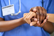 © Koegelenberg Coop/peopleimages.com - Doctor, nurse and holding hands with patient for empathy, sympathy or care in support at hospital. Closeup, medical employee or caregiver with touch for understanding, healthcare or help at clinic