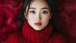 © Resad - Beautiful image of a young Asian woman wearing a red sweater.