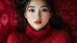 © Resad - Beautiful image of a young Asian woman wearing a red sweater.