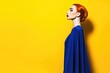 © Konstiantyn Zapylaie - Elegant redhead in blue attire against bold yellow background