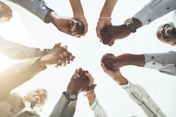 Wall Mural - Business people, team building and holding hands at office for collaboration, trust and care. Low angle, employee and motivation with gesture in circle for solidarity, agreement and partnership