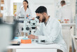 © CineLens2024/peopleimages.com - Man, scientist and check with microscope in lab with disease experiment, medical study and dna process. Researcher, biotech and molecule exam for engineering, vaccine research and healthcare solution