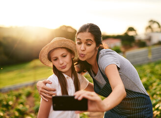 Woman, child and hug on farm for selfie, social media post and agriculture. Family business, mother and daughter with pout for photography, website update and connectivity in Colombia countryside