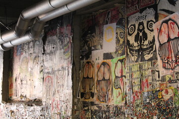 A narrow alley in Portland, where thousands of colorful pieces of gum are stuck to the walls by locals and tourists alike, creating a unique and quirky display.