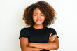 © Elena - Young black woman is smiling with her arms folded on a white background