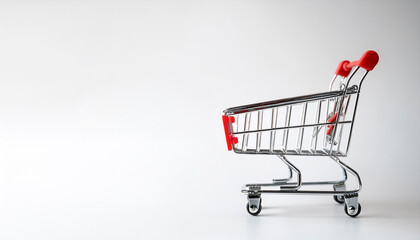 Empty shopping cart with red handle on side position provides copy space for text. background concept isolated white