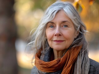 Gray haired older woman portrait standing in the park