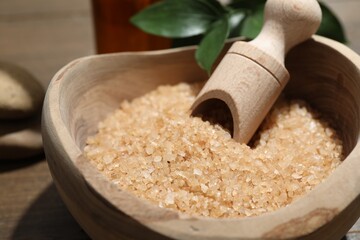 Sticker - Bowl with sea salt and leaves on wooden table, closeup. Spa treatment