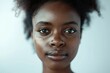 © Isuru - Close up portrait of African American woman against white background.