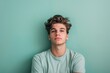© spyrakot - Relaxed Young Man Against Pastel Green Monochrome Background for Calm Design Projects
