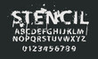 © paseven - stencil grunge lettering in abstract letters with spots and drips. Vector set of alphabet letters written in white paint on black background. Spattered font