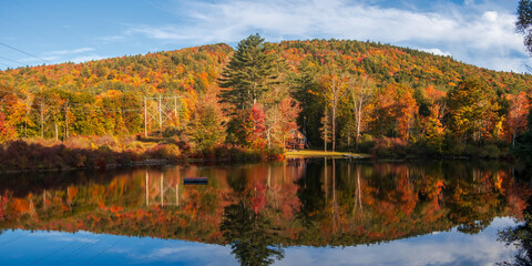 Wall Mural - panoramic view of colorful trees by the lake rescue in vermont countryside.