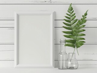 White frame mockup with green fern, two glass vases and wood background