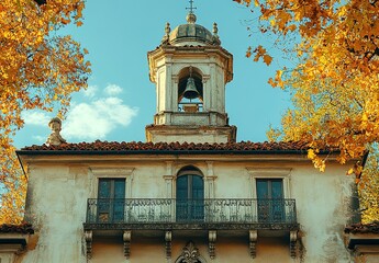 A close-up of a historic building with a bell tower and balcony.