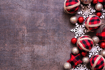 Poster - Christmas side border of red and black gingham ornaments, baubles and snowflakes. Top view on a dark brown background. Copy space.
