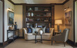 © ATALLAH AHMED  - Elegant living room with cream sofa  navy blue pillows  and dark wood bookshelf