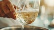 © familymedia - A refreshing pour of white wine into a glass during golden hour, capturing the sparkling elegance and timeless appeal of fine wine in gourmet settings.