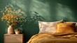 © familymedia - Cozy bedroom featuring an orange flower arrangement in a vase, orange pillow and blanket, all against a rich green wall creating a warm atmosphere.