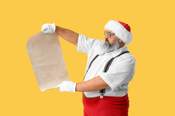 Wall Mural - Santa Claus with blank letter on yellow background