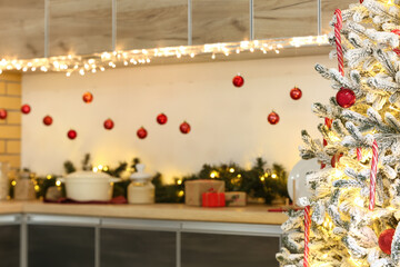 Beautiful Christmas tree in decorated kitchen