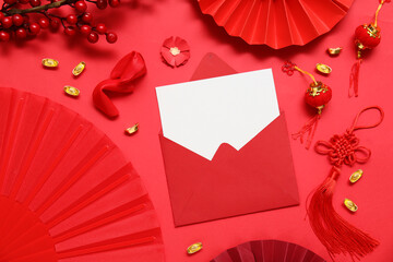 Envelope with blank card, fortune cookies and Chinese symbols on red background. New Year celebration