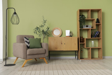 Wall Mural - Interior of living room with armchair, shelf unit and mirror on commode