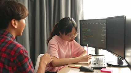 Slow motion back end software developer engineer for computer programming working together on debugging writing computing code, solving complex algorithms display on monitor in office. Burgeoning