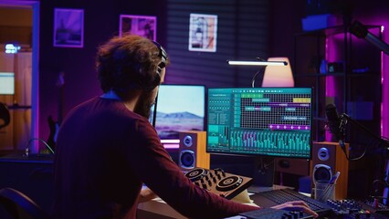 Poster - Musician recording electronic piano tunes and having fun in his home studio, editing and mixing recorded tracks to enhance the sound and achieve high quality audio. Producing lively songs. Camera B.