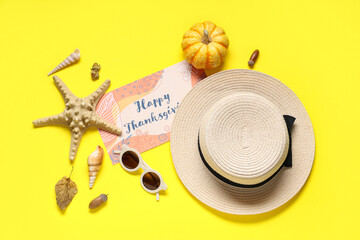 Wall Mural - Card for Thanksgiving Day with hat, seashells and pumpkin on yellow background