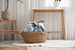 © Pixel-Shot - Wicker basket full of dirty clothes in laundry room
