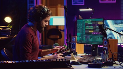 Leinwandbilder - Artist improving the sound quality of audio recordings in home studio, handling mixing console and controls. Producer uses his creative vision to manipulate sounds, audio equipment. Camera A.