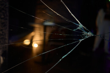 Cracked Glass Window Featuring Distinct Impact Marks Evident on Its Surface and Structure