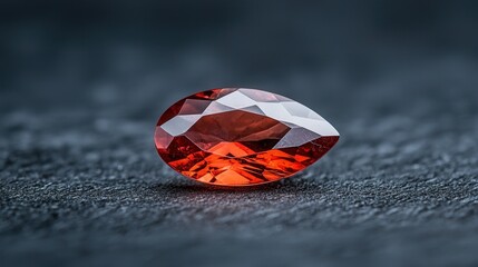 Vivid marquise-cut ruby displaying brilliance and elegance on a dark surface, captured in a close-up view