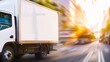 © Oksana - A delivery truck moves fast through a blurred city street. Concept of urban logistics and speed. For transportation services content.