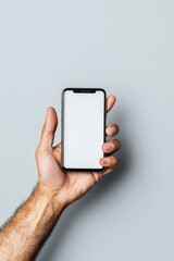 A close-up view of a hand holding a smartphone with a blank screen. Ideal for displaying app designs, mobile technology, or lifestyle concepts.