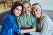 © TamJam/peopleimages.com - Family, relax and smile in home for portrait, weekend visit or support with hug on sofa. Elderly couple, Brazil woman or happy in living room for retirement care, relationship development and reunion