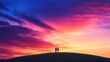 © peerawat - A peaceful sunrise scene of a couple standing on a grassy hill, holding hands and gazing at the vibrant colors of the sky as the first light of daybreak spreads across the landscape.