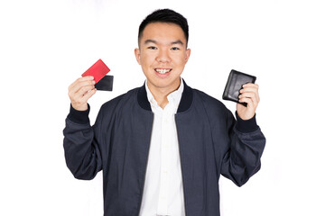 A young man holding up his wallet and two credit cards